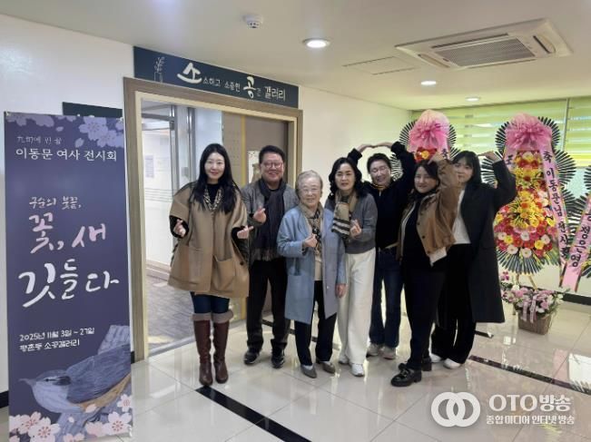 이동문 작가가 평촌동 소공갤러리 입구 앞에서 가족들과 함께 전시 기념 촬영을 가졌다